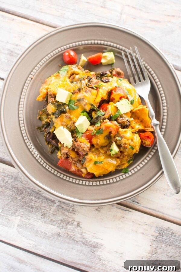 Slow Cooker Taco Casserole for Busy Weeknight Dinners 3 gold plate with serving of taco casserole with fork on side