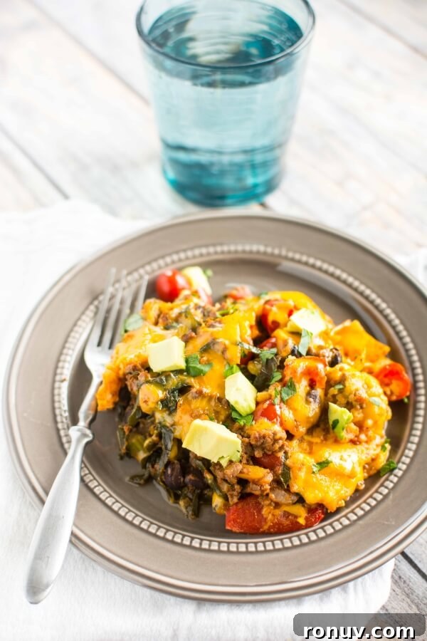 Slow Cooker Taco Casserole for Busy Weeknight Dinners 5 gold plate with serving of taco casserole with fork on side; water glass in background