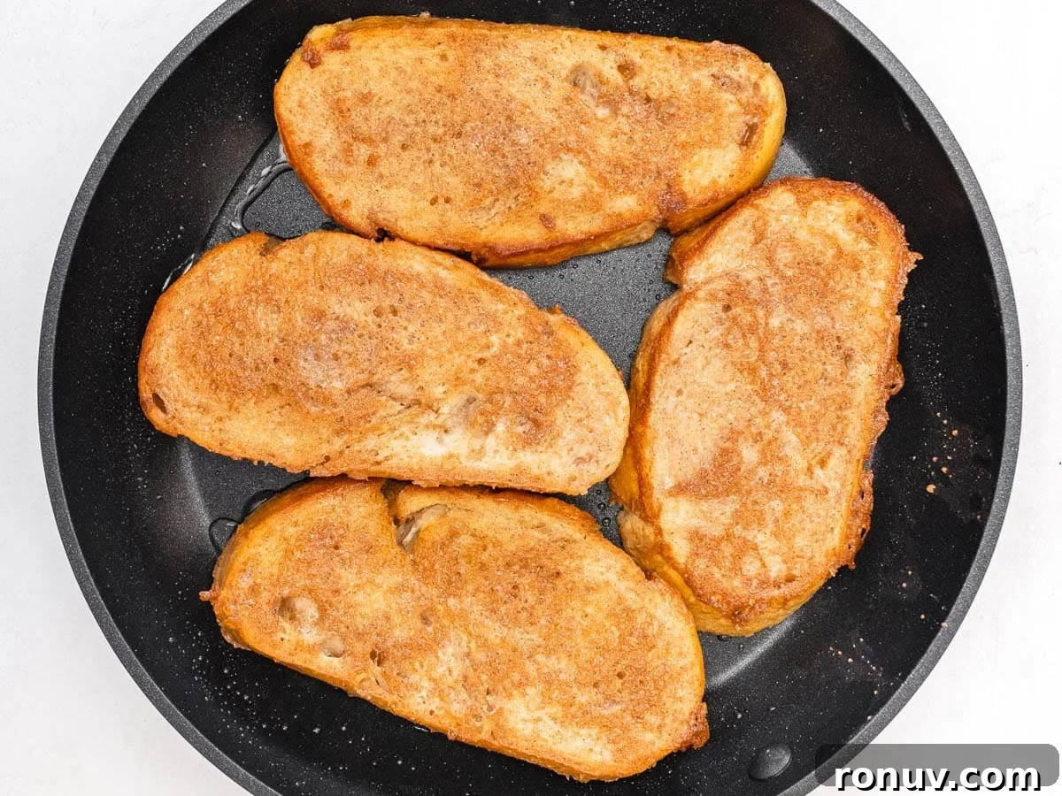 Vegan French Toast Recipe with Cinnamon Maple Syrup 11 cinnamon batter covering 4 slices of bread in a skillet