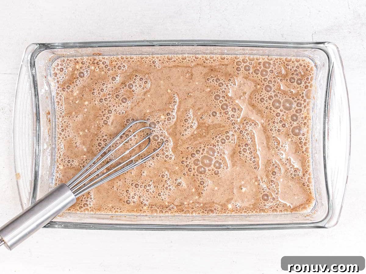 Vegan French Toast Recipe with Cinnamon Maple Syrup 8 vegan batter in a casserole for French toast with a whisk