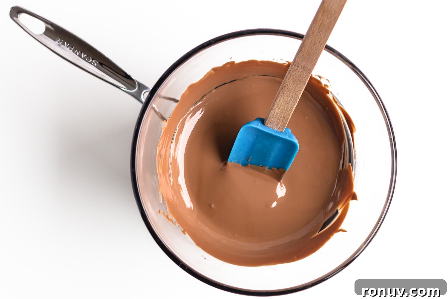 How to Make Chocolate Halloween Popcorn Balls 6 Glass bowl of melted chocolate over small pot of simmering water.
