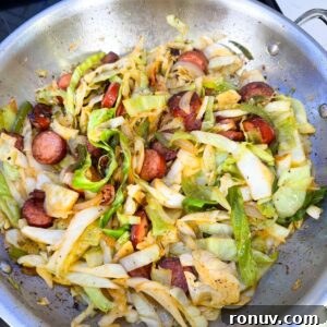 Southern Fried Cabbage Recipe with Bacon and Onions 7 Cabbage in a pan with sausage.