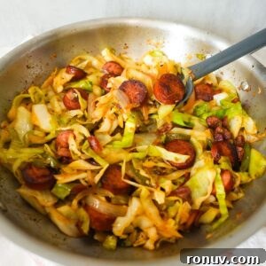 Southern Fried Cabbage Recipe with Bacon and Onions 8 Southern fried cabbage with bacon, sausage, and onions, cooked until tender and full of Cajun flavor.