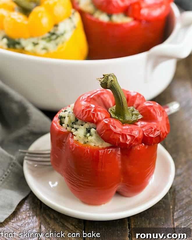 Cheese, Spinach and Rice Packed Peppers - a vegetarian stuffed pepper recipe with creamy rice, gooey nutty Gruyere, spinach and onions! Rice Packed Peppers on a white plate