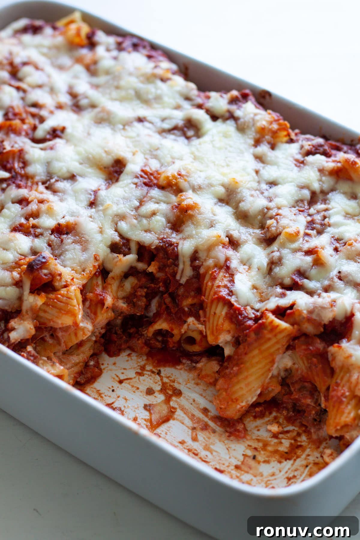Baked Rigatoni with Cheese and Tomato Sauce 2 A baking dish with rigatoni al forno and a piece taken out of the pasta dish.