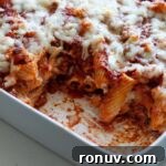 Baked Rigatoni with Cheese and Tomato Sauce 12 A baking dish with rigatoni al forno and a piece taken out of the pasta dish.