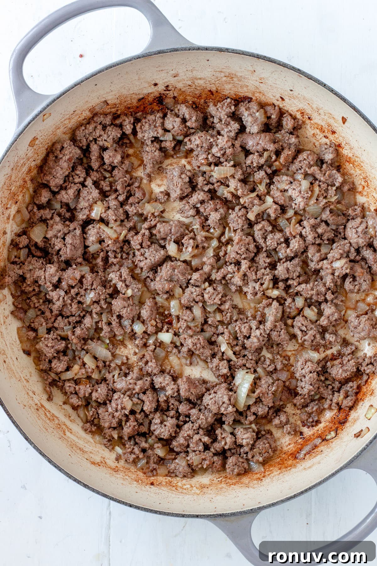 Baked Rigatoni with Cheese and Tomato Sauce 5 Ground beef and onions cooking in a large skillet.