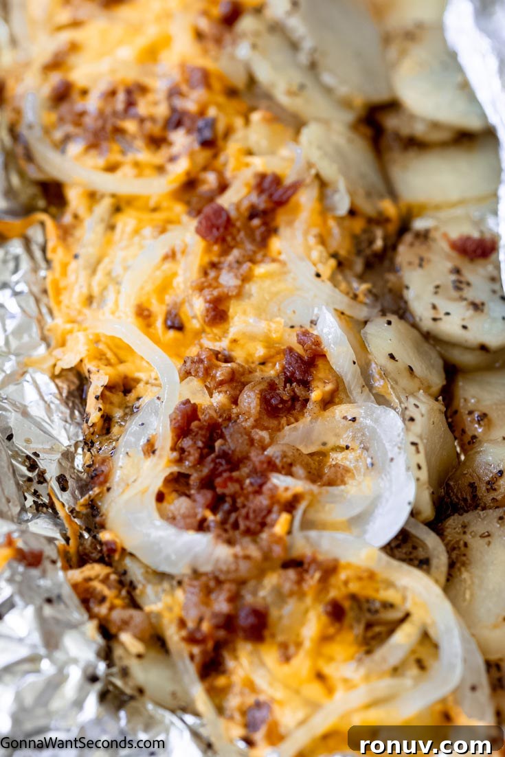 Campfire potatoes in aluminum foil topped with cheddar, onion, and bacon simple campfire potatoes topped with cheese, onion, and bacon, in aluminum foil
