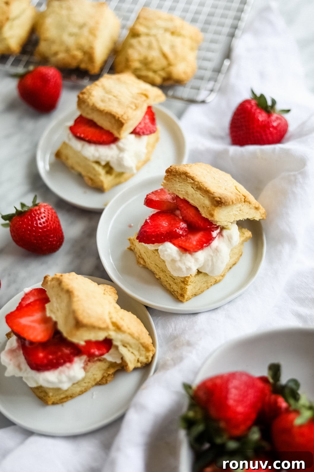 Flaky Bacon, Cheddar and Chive Breakfast Biscuits Recipe 8 Easy strawberry shortcake on white plates.