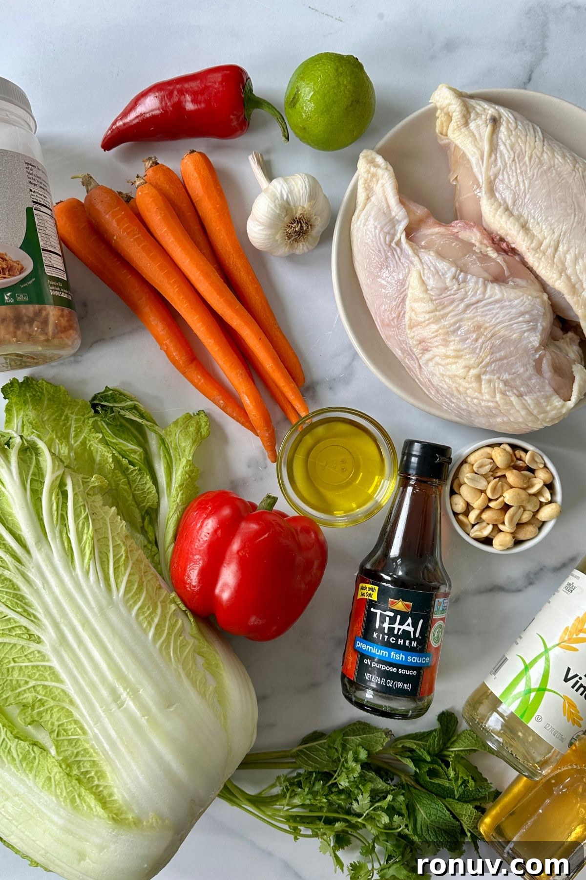 Vietnamese Chicken Salad with Tangy Nuoc Cham Dressing 2 Ingredients for Vietnamese chicken salad including Napa cabbage, carrots, bell peppers, fresh herbs, poached chicken, and premium fish sauce.