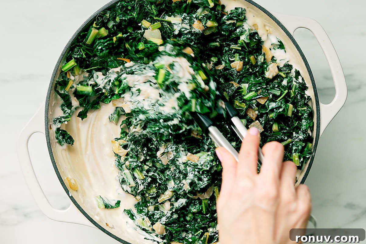 Creamed Kale Recipe: Garlic and Parmesan Side Dish 11 Stirring cooked kale into a creamy cheesy mixture to make easy creamed kale.