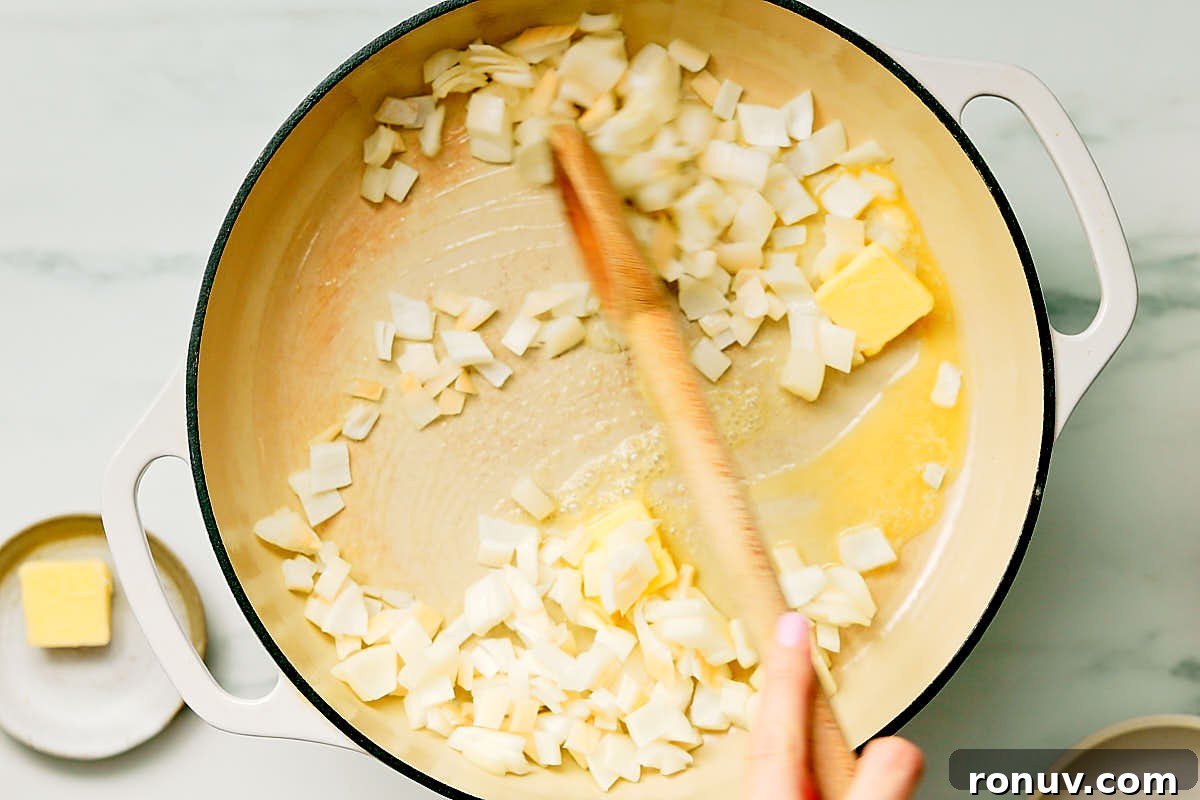 Creamed Kale Recipe: Garlic and Parmesan Side Dish 7 Melting butter and sauteeing onions in a pan to make easy Creamed Kale.
