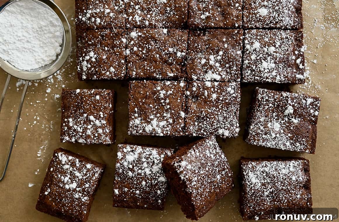 Brownies cut cleanly into squares and dusted with powdered sugar