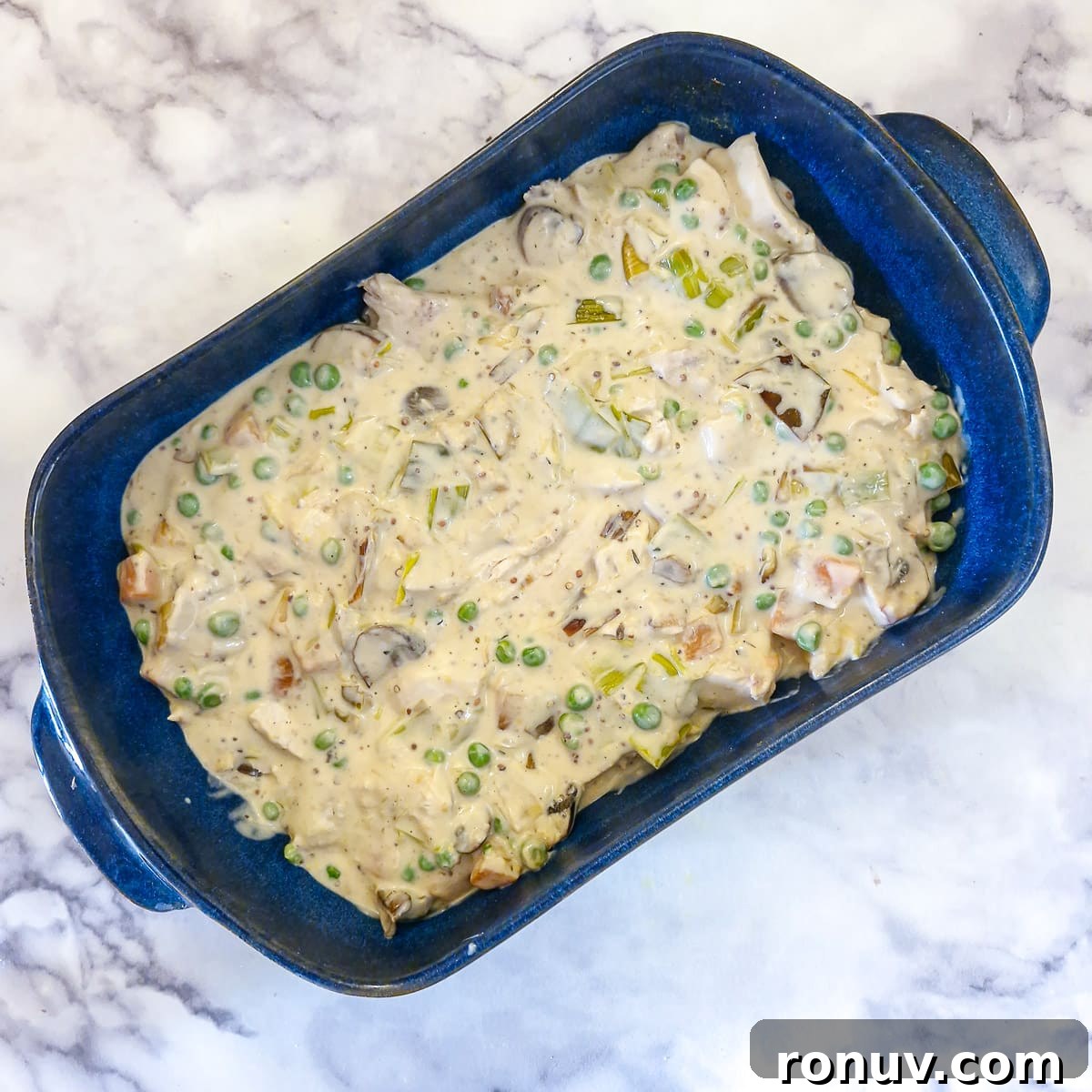 Turn Leftover Chicken Into Shepherd's Pie 11 Creamy chicken sauce in a blue serving dish.