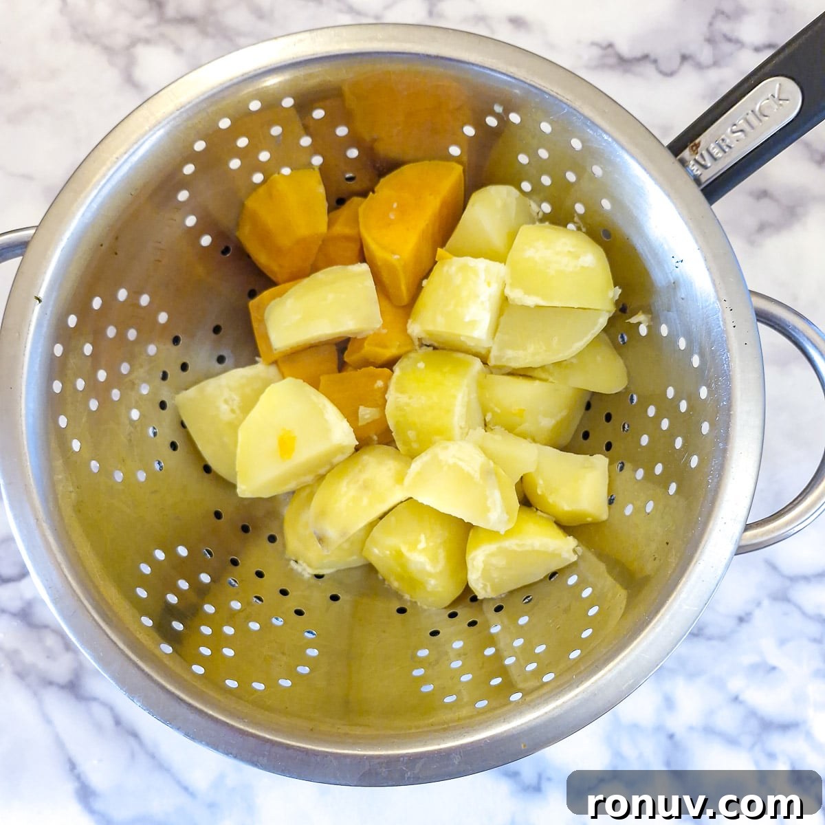 Turn Leftover Chicken Into Shepherd's Pie 5 Boiled potatoes and sweet potatoes draining in a colander.