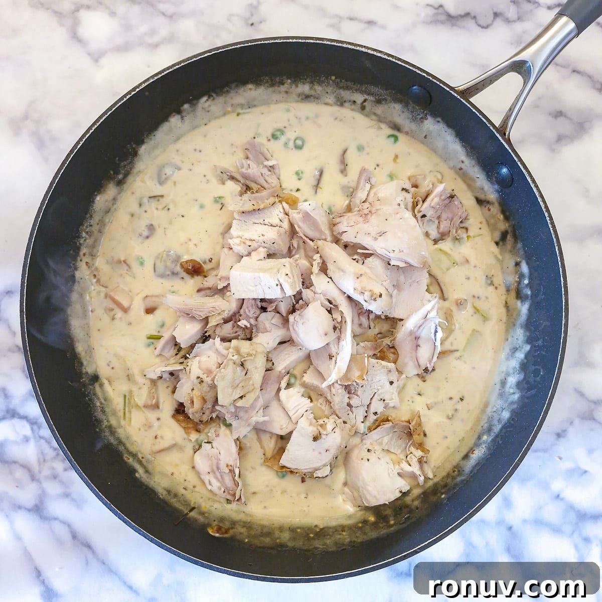 Turn Leftover Chicken Into Shepherd's Pie 10 Diced leftover cooked chicken being added to the creamy vegetable sauce.