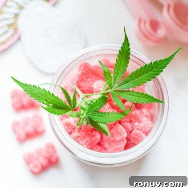 A picture of a container of pink gummies with a cannabis leaf on top.