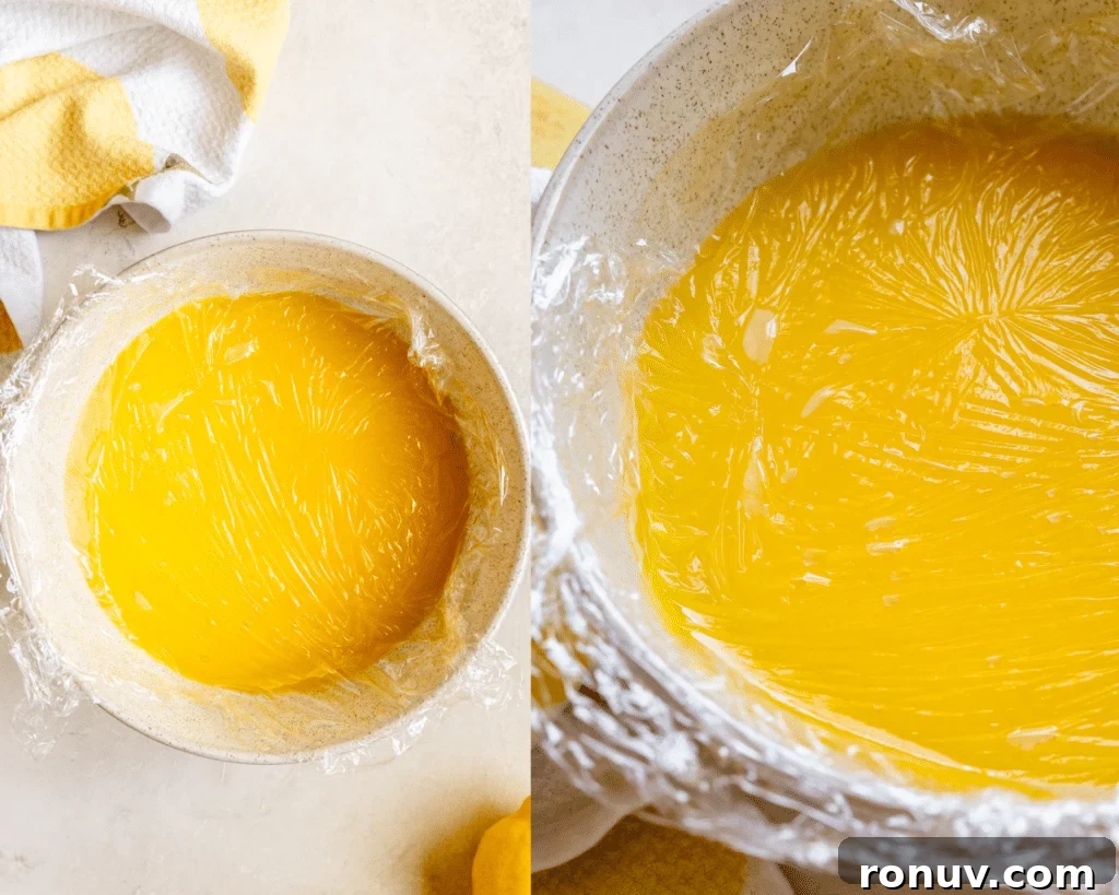 Silky Homemade Lemon Curd Recipe 7 plastic wrap on top of lemon curd in a bowl.