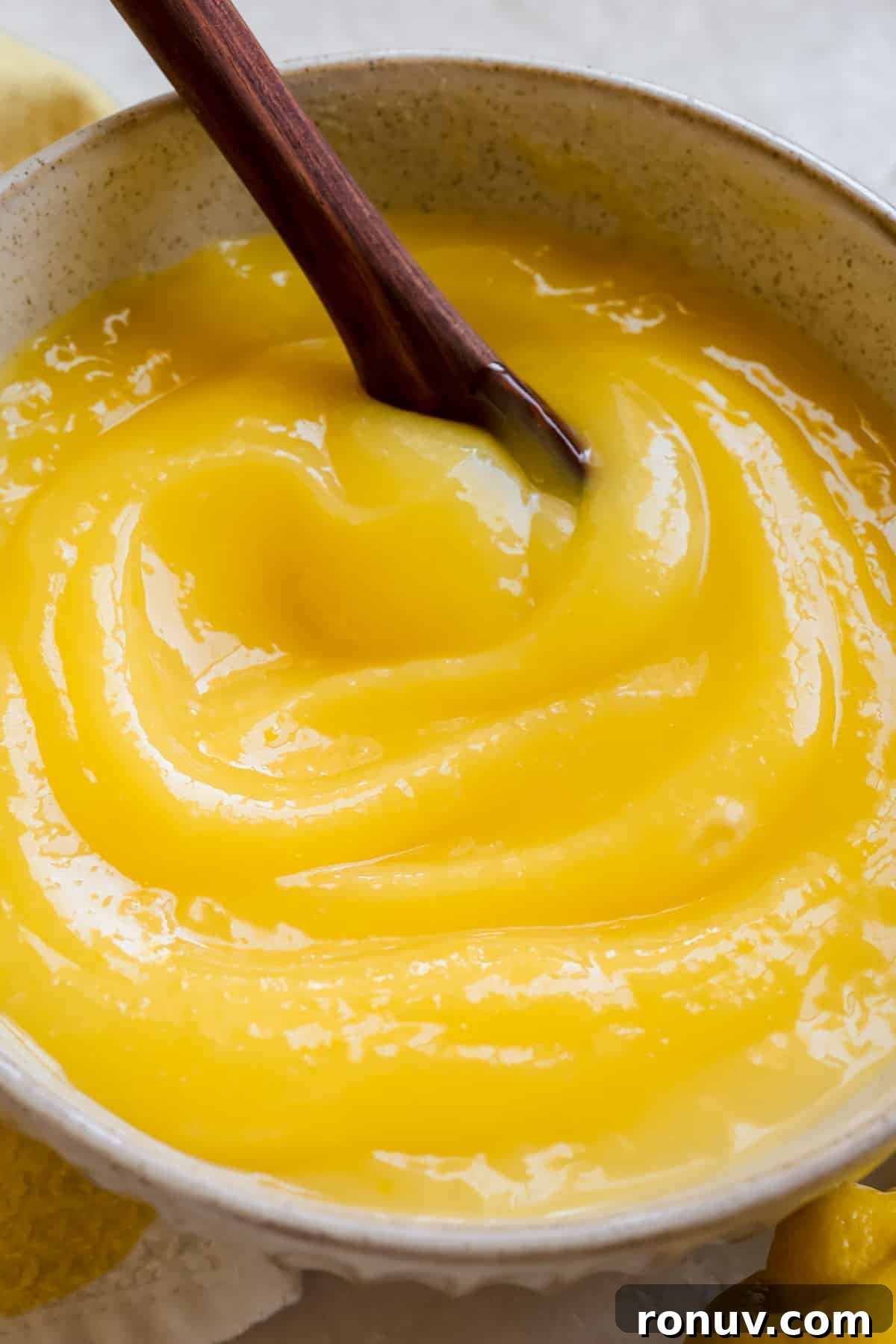 Silky Homemade Lemon Curd Recipe 8 curd in a glass bowl.