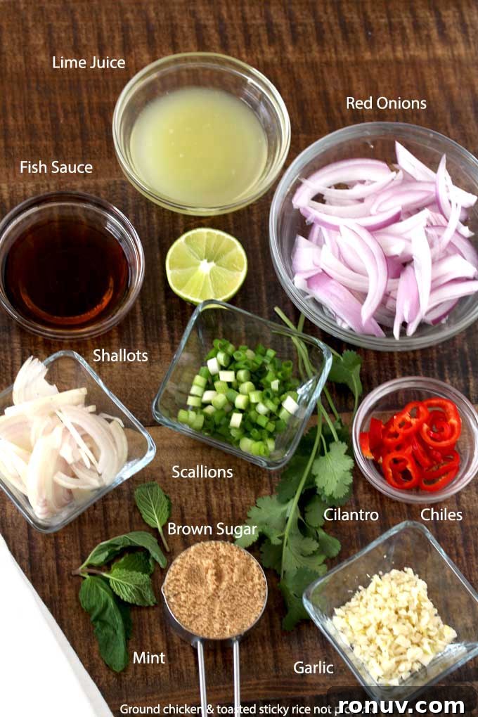 Thai Larb Gai (Chicken Larb) Recipe 4 Chicken larb recipe ingredients on a wooden surface.