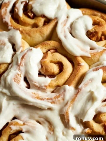 Closeup of Sourdough Discard Apple Cinnamon Rolls with frosting.