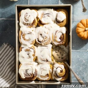 Pumpkin Cinnamon Rolls Recipe with Sourdough Discard 16 Sourdough Discard Pumpkin Cinnamon Rolls in a baking pan.