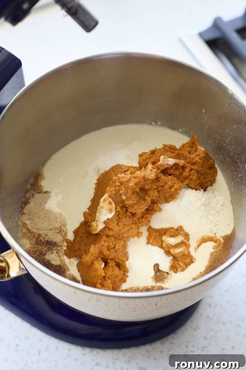 Pumpkin Cinnamon Rolls Recipe with Sourdough Discard 4 Ingredients in the bowl of a stand mixer.