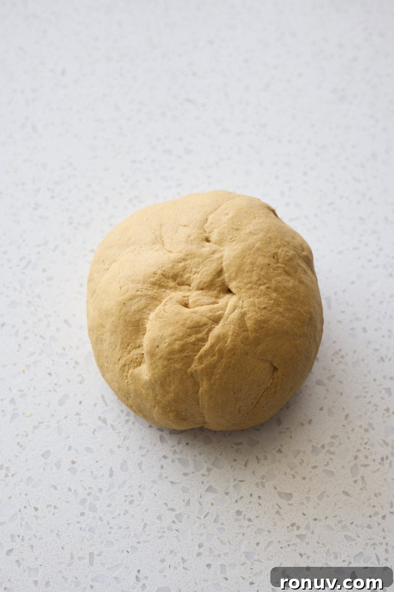 Pumpkin Cinnamon Rolls Recipe with Sourdough Discard 5 Dough in a smooth ball after kneading.