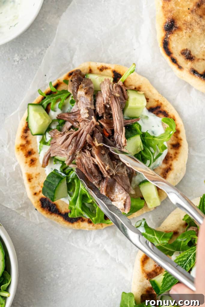 Grilled Greek Lamb Pitas with Tzatziki and Feta 12 Adding the shredded lamb to the pitas.