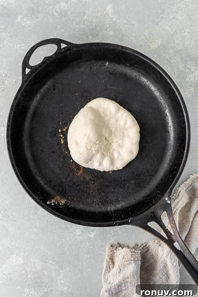 Grilled Greek Lamb Pitas with Tzatziki and Feta 9 Cooking the pita in a dry cast iron pan.