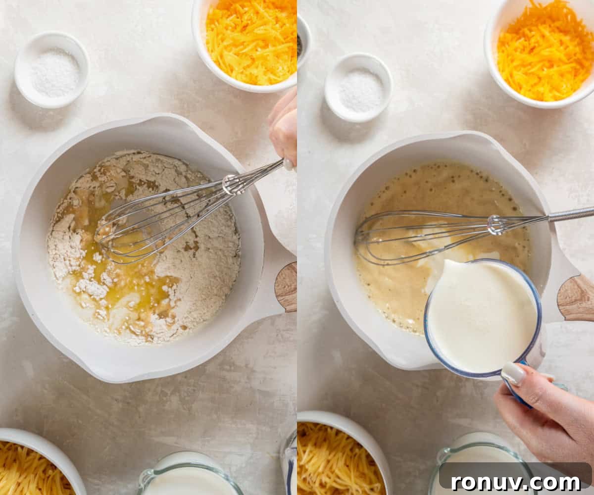 Whisking together the roux with the heavy cream and milk in a saucepan to make the cheese sauce.