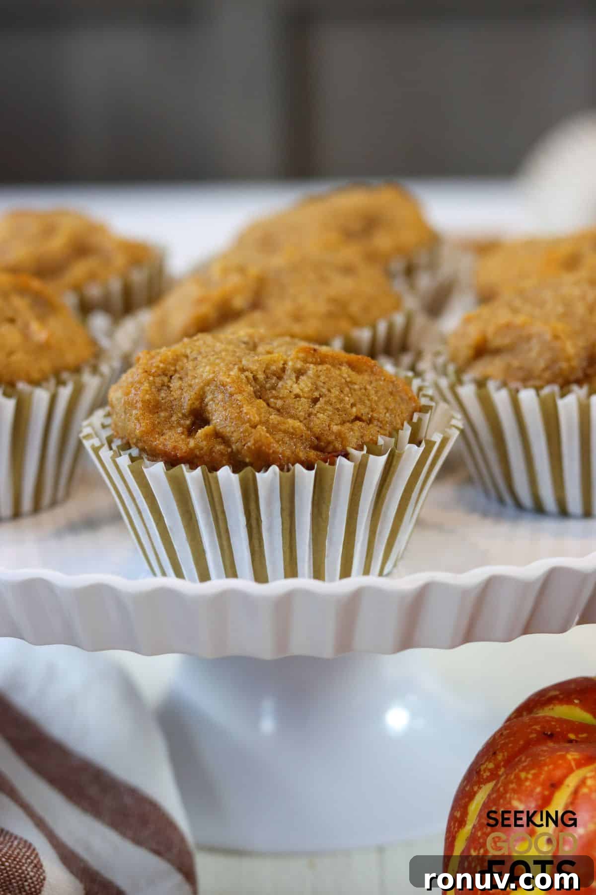 Gluten-Free Pumpkin Muffins That Taste Like Fall 4 Healthy gluten free pumpkin muffins set out on a cake stand.