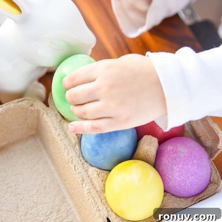 multicoloured eggs in an egg box