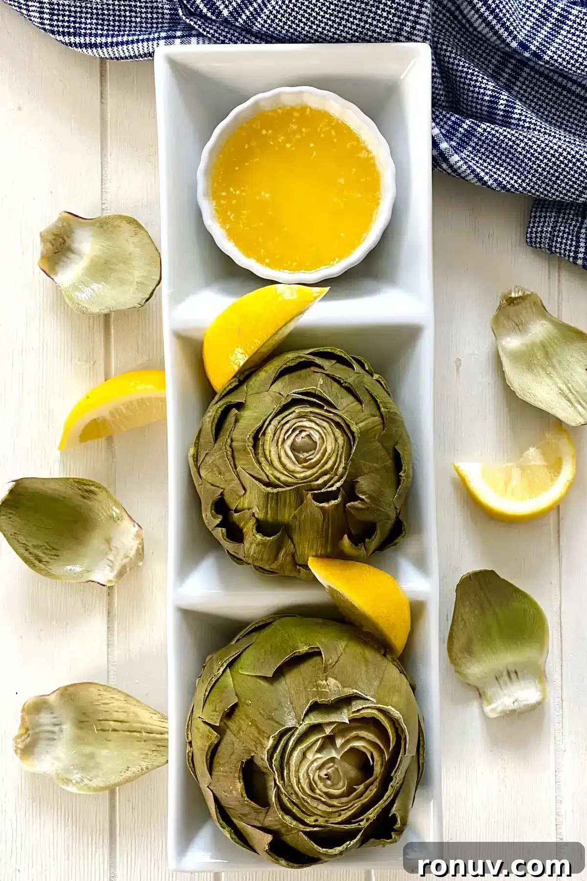 How to Cook Artichokes in the Microwave 11 2 cooked microwave artichokes with melted butter and lemon wedges.