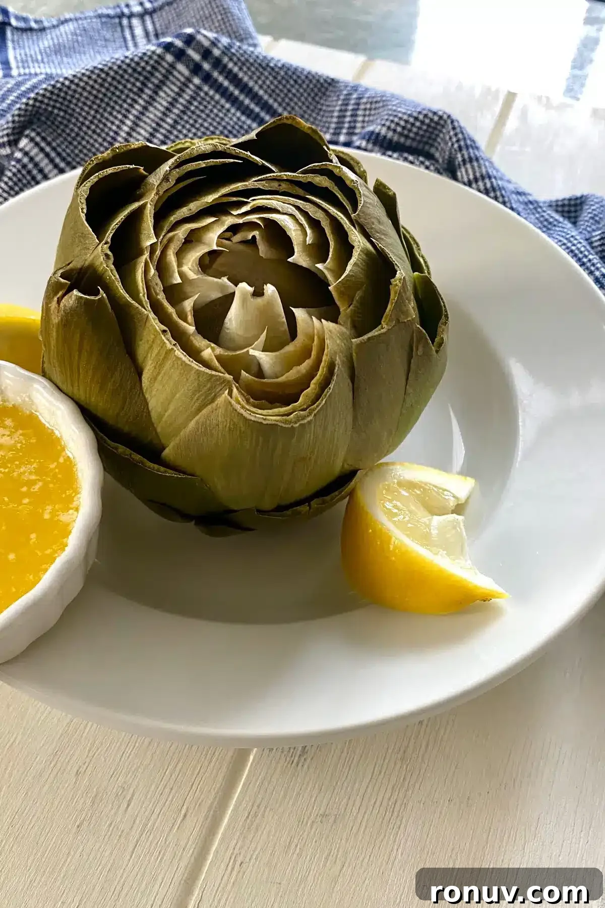 How to Cook Artichokes in the Microwave 10 cooked artichoke with melted butter.