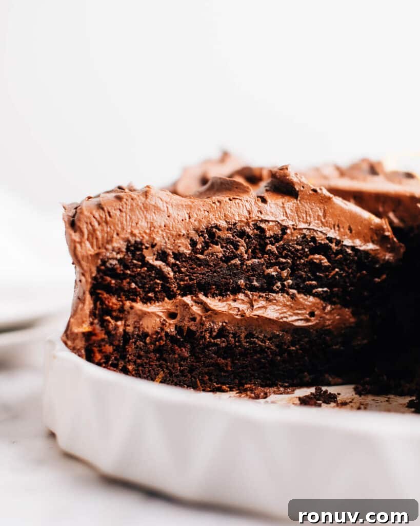 Valentine's Day Dessert Recipes for Date Night 18 Frosted moist chocolate cake with a slice removed so you can see inside.