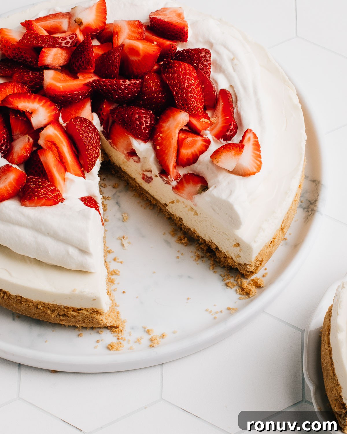 Valentine's Day Dessert Recipes for Date Night 20 No-bake strawberry cheesecake on a plate.