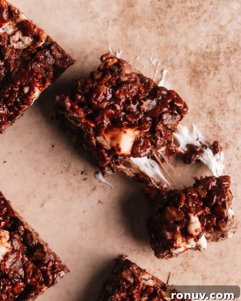 Valentine's Day Dessert Recipes for Date Night 4 Chocolate Rice Krispie Treat pulled apart with stretchy marshmallows.