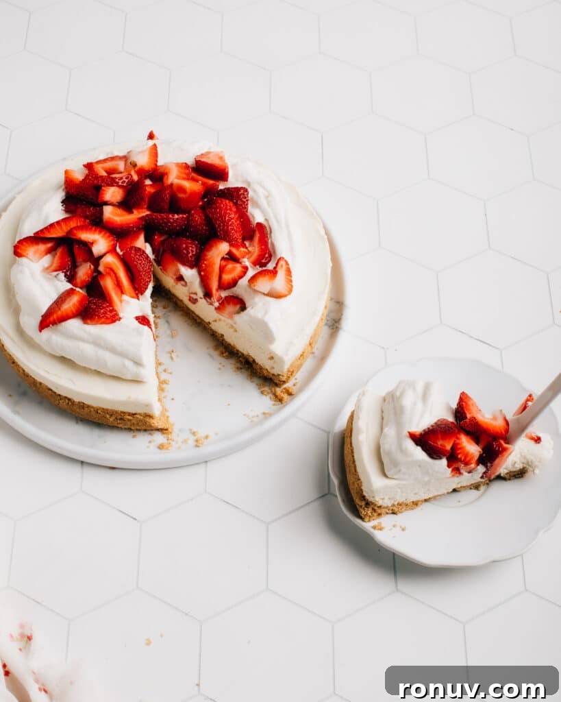 Valentine's Day Dessert Recipes for Date Night 8 No-bake cheesecake topped with strawberries on a plate.