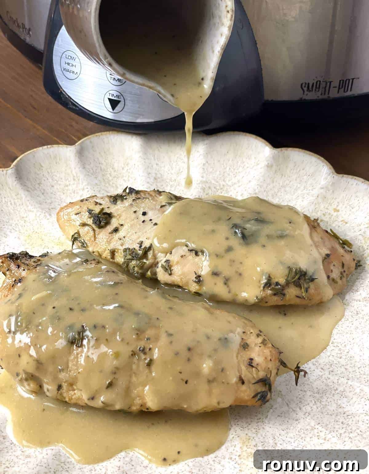 Slow-Cooker Turkey Tenderloins in Honey Mustard Gravy 6 Two whole turkey tenderloins on a scalloped plate with gravy being poured over the top.