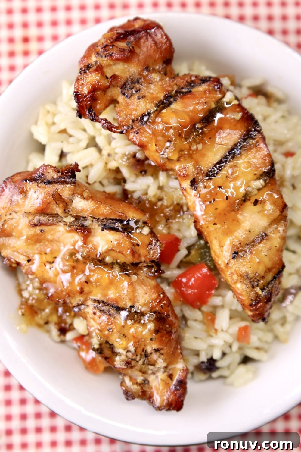 Sticky Apricot-Glazed BBQ Chicken Tenders 2 Grilled chicken tenders with rice pilaf in a bowl