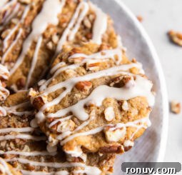 maple brown sugar cookie with chopped pecans and maple drizzle on plate.
