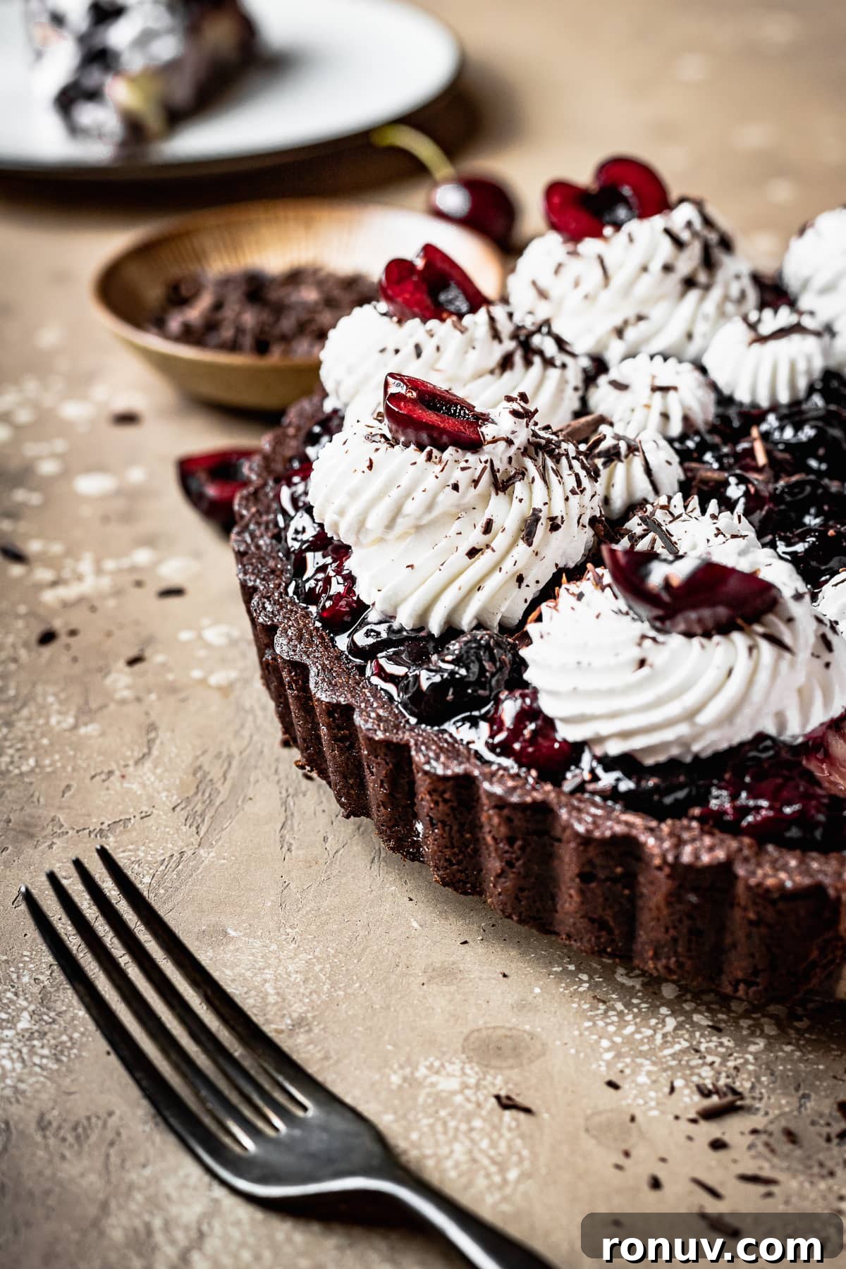 Decadent Chocolate Cherry Tart Recipe 5 A chocolate tart shell filled with cherries and topped with rosettes of piped whipped cream.