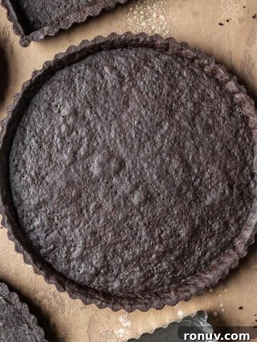 A round baked chocolate tart crust.
