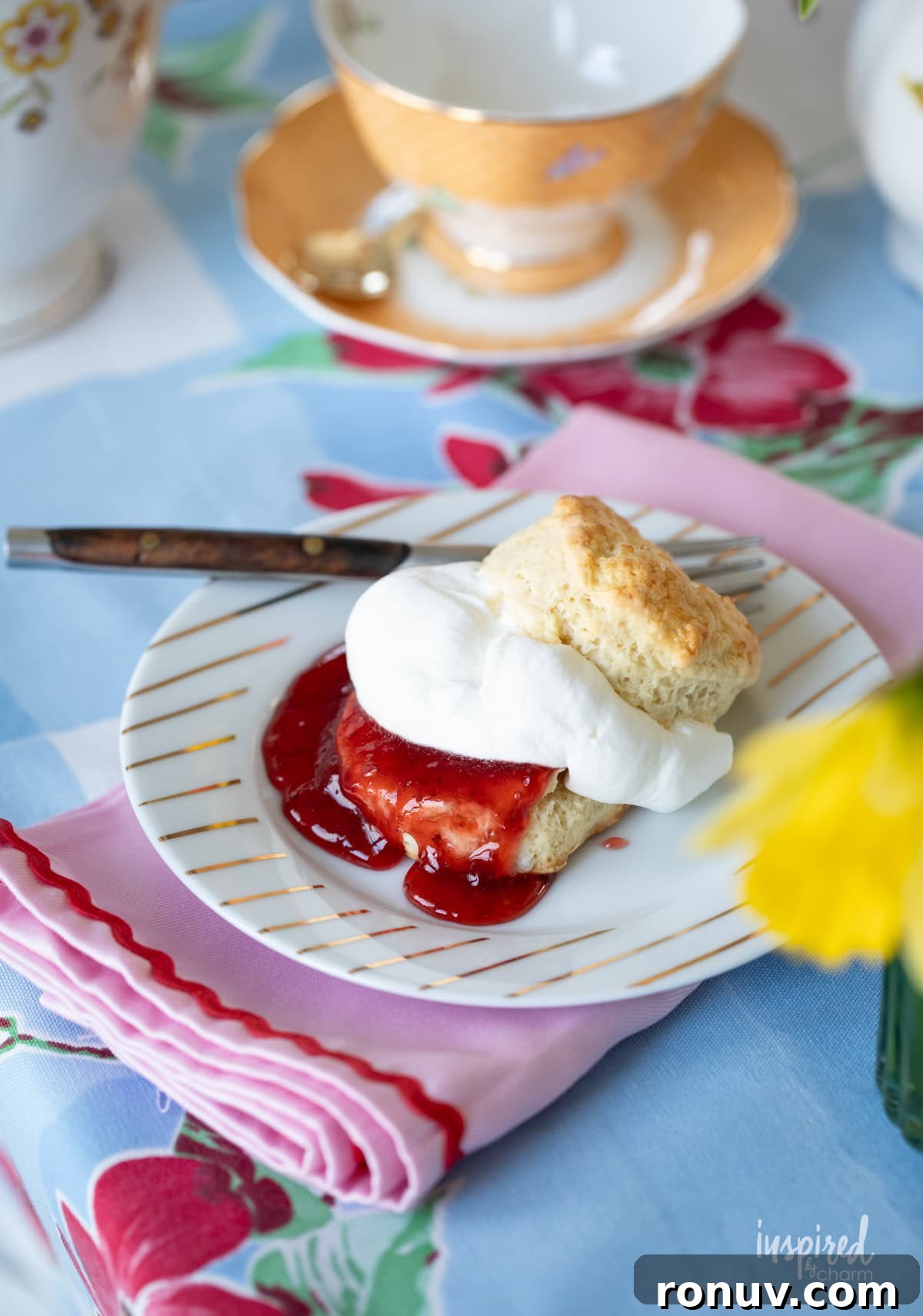Classic Buttery Homemade Scones Recipe 2 scone on a plate served with jam and whipped cream.