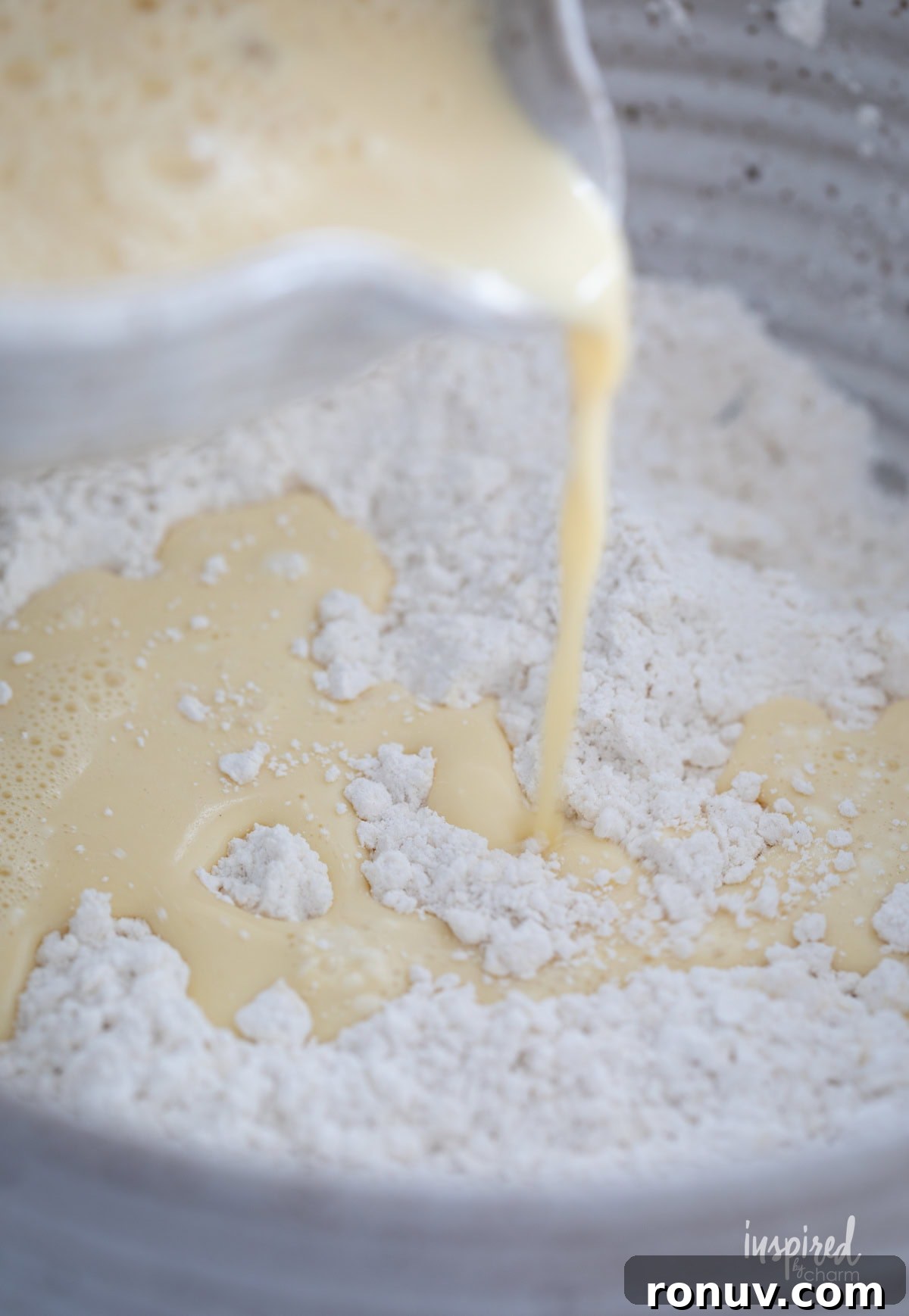 Classic Buttery Homemade Scones Recipe 9 bowl pouring wet ingredients into dry ingredients to make homemade scones.
