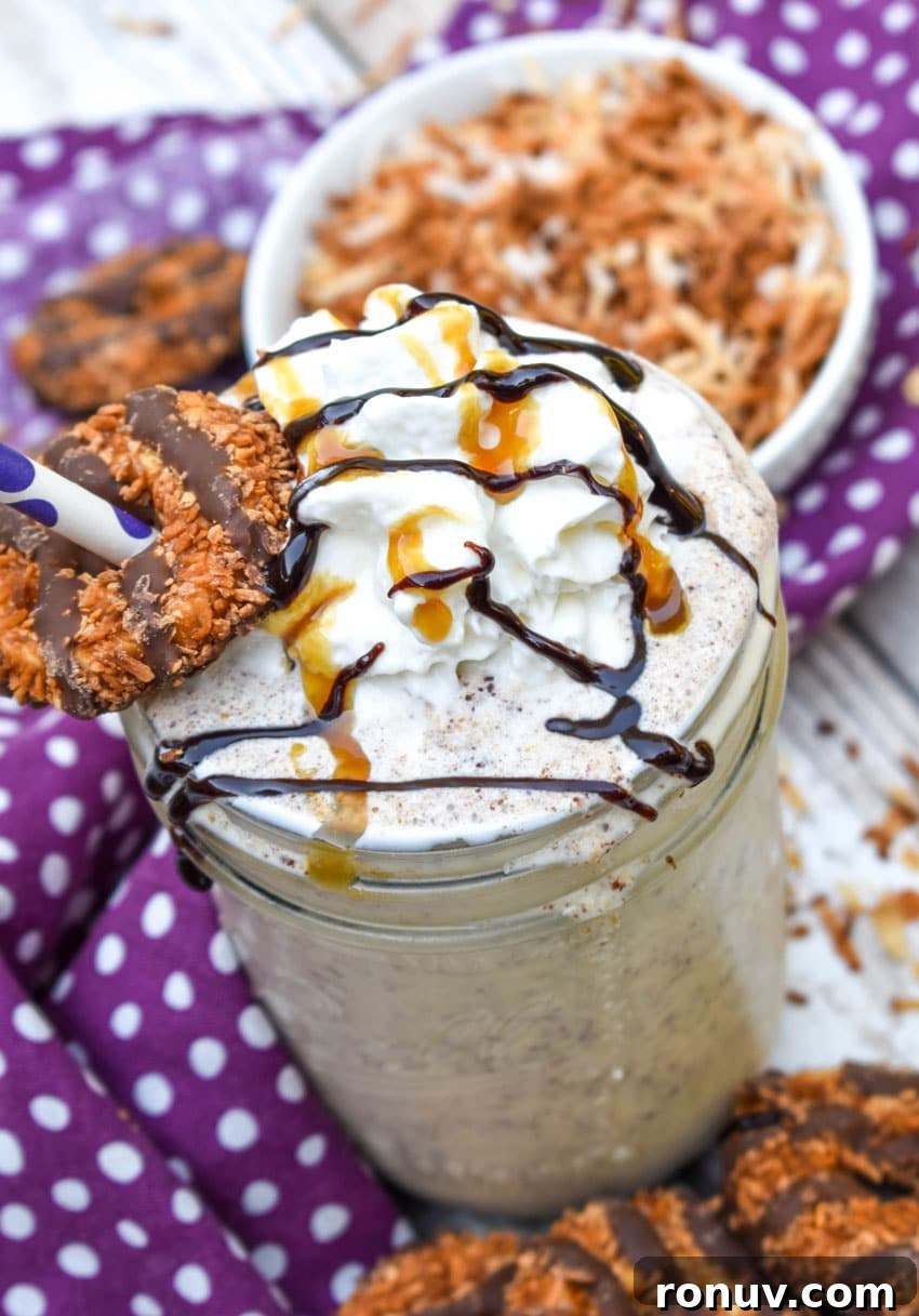 Samoa Cookie Milkshake Recipe with Caramel and Toasted Coconut 2 a samoa cookie milkshake in a small glass jar on a wooden table