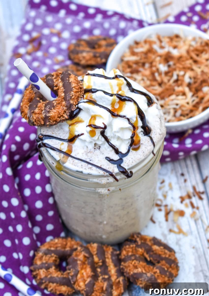 Samoa Cookie Milkshake Recipe with Caramel and Toasted Coconut 4 a samoa cookie milkshake in a small glass jar on a wooden table