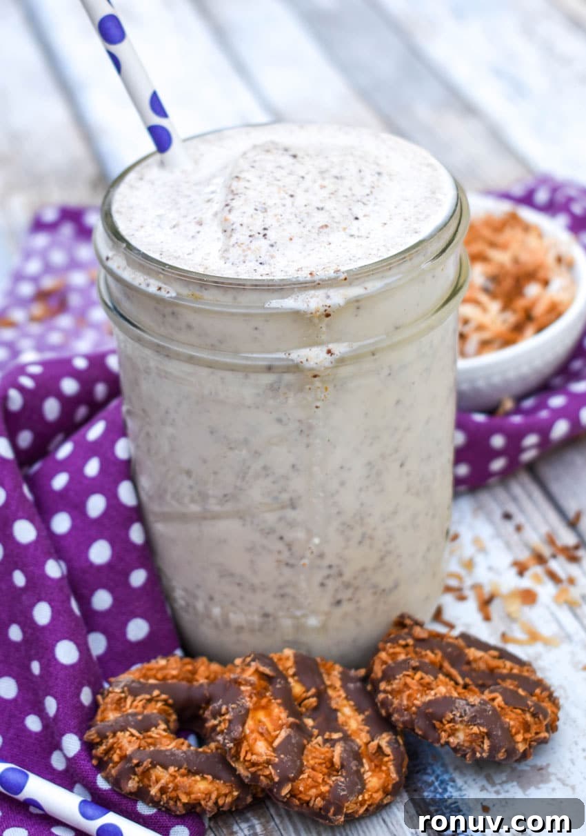 Samoa Cookie Milkshake Recipe with Caramel and Toasted Coconut 5 a samoa cookie milkshake in a small glass jar on a wooden table