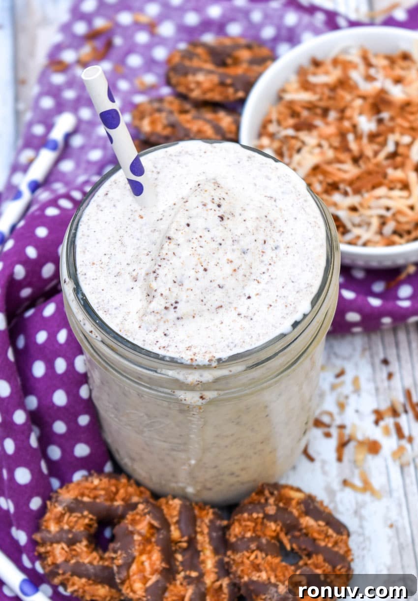 Samoa Cookie Milkshake Recipe with Caramel and Toasted Coconut 6 a samoa cookie milkshake in a small glass jar on a wooden table
